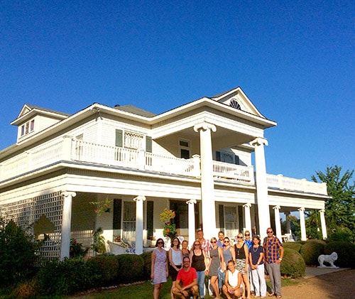 Group of people stand in front of beautiful building