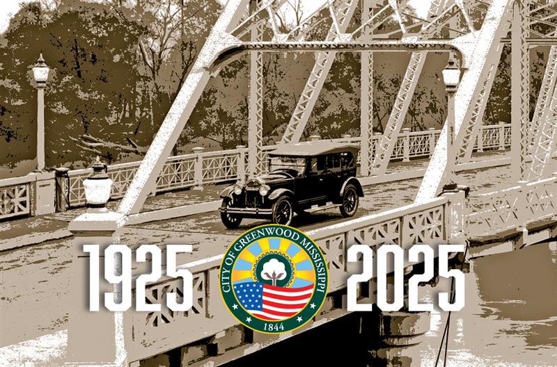 An old car drives through Keesler Bridge