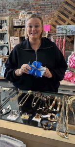 Casey holding an item with a blue bow