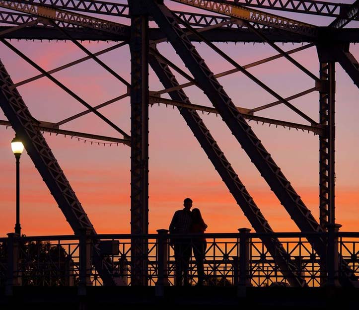Keesler bridge at sunset with couple