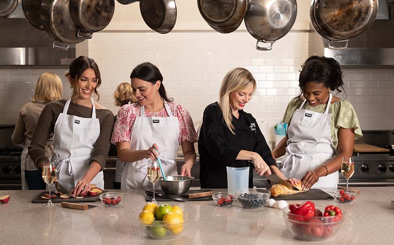 women sharing a laugh at viking cooking school